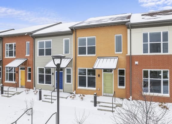 a row of houses in the snow