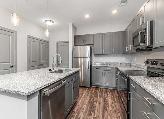 Kitchen with gray cabinets and white countertops at The Parker Myrtle Beach, South Carolina
