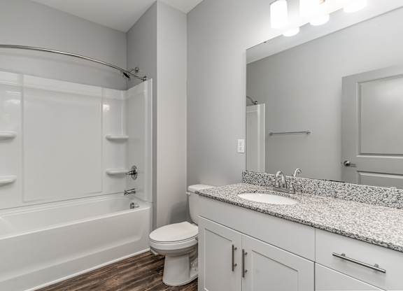 Bathroom with a bathtub toilet and sink at The Parker Myrtle Beach, South Carolina