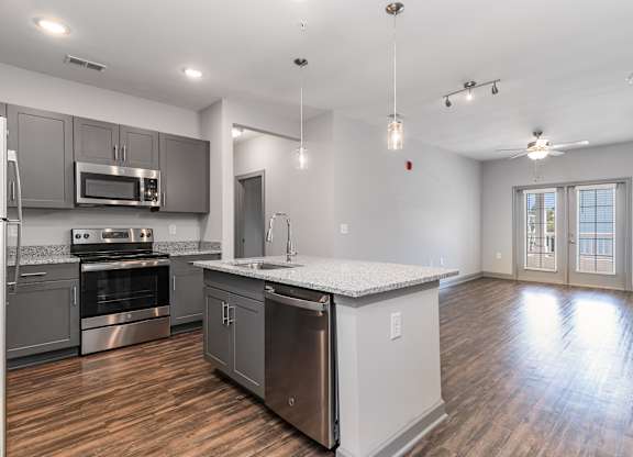 Kitchen and living room with an island and stainless steel appliances at The Parker Myrtle Beach, South Carolina
