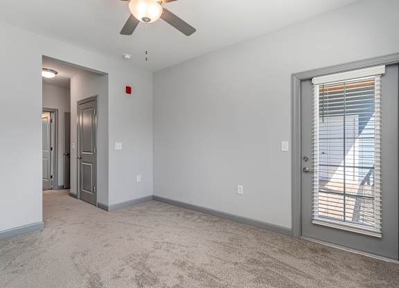 Bedroom with a ceiling fan and a door to a balcony at The Parker Myrtle Beach, Myrtle Beach, SC