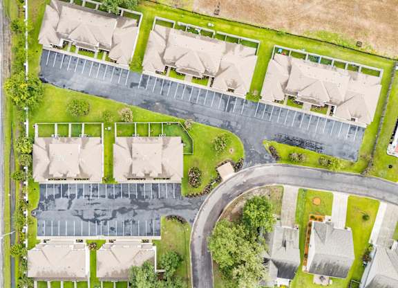 A residential area with houses and a parking lot.
