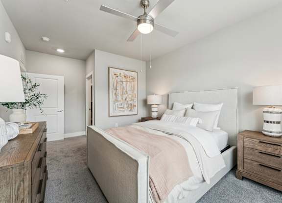 A bedroom with a bed, nightstand, and a ceiling fan at The Hendry Apartments, Florida