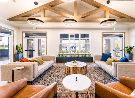 Living room with couches and chairs and a table at The Parker Austin, Pflugerville, TX, 78660