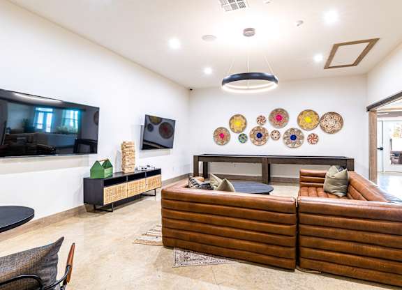 Living room with couches and a tv at The Parker Austin, Pflugerville, TX