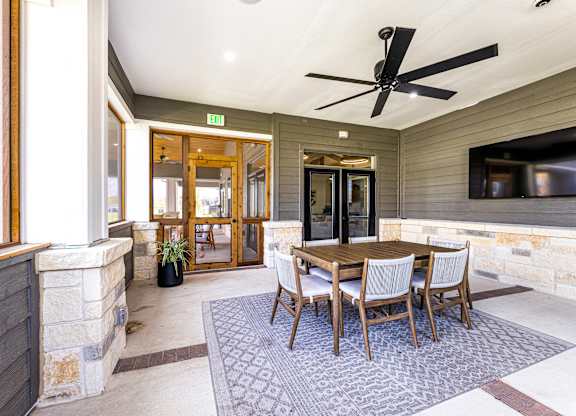 Dining area with a table and chairs and a tv at The Parker Austin, Pflugerville, 78660