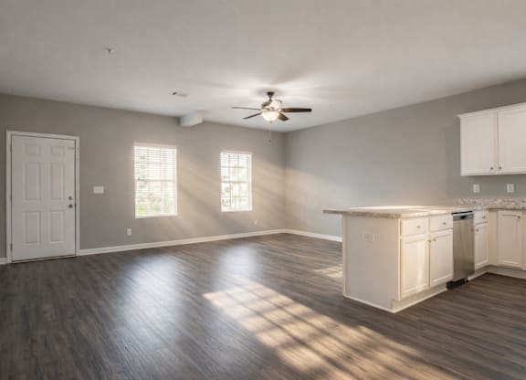 Spacious room with kitchen area and a ceiling fan at Club Villas Apartments, Kathleen, Georgia