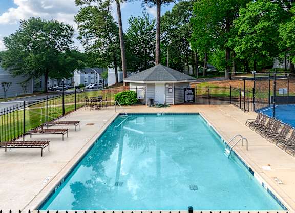 A Swimming Pool With Relaxing Area at Avondale Place Apartments, Georgia