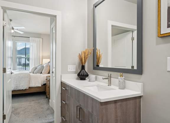 bathroom sink with view into bedroom at The Hendry Apartments, Fort Myers, Florida
