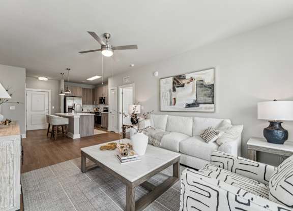 A modern living room with a white couch and a coffee table at The Hendry Apartments, Florida
