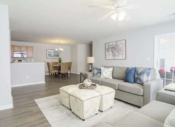 A living room with a grey couch and a white coffee table.