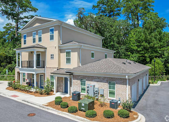 A two-story house with a garage and a driveway.