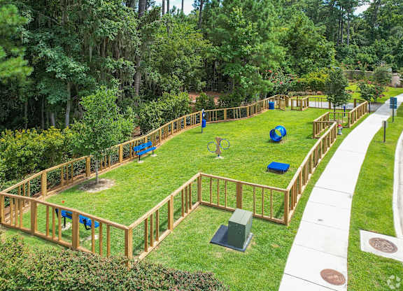A playground with a wooden fence and a slide.