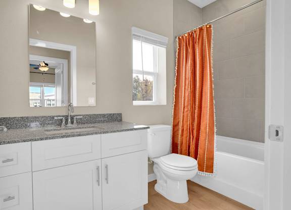 A bathroom with a white toilet and a sink.