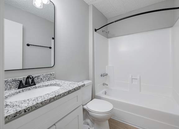 A Bathroom With Marble Countertop at Avondale Place Apartments, Avondale Estates, GA