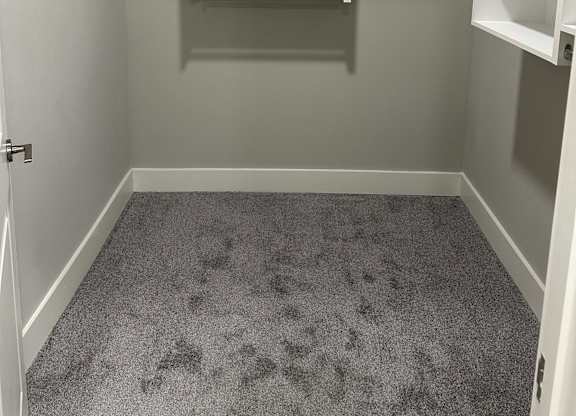 A small, empty room with a white door and a white shelving unit at The Beacon at 331 Apartments, Santa Rosa Beach, 32459