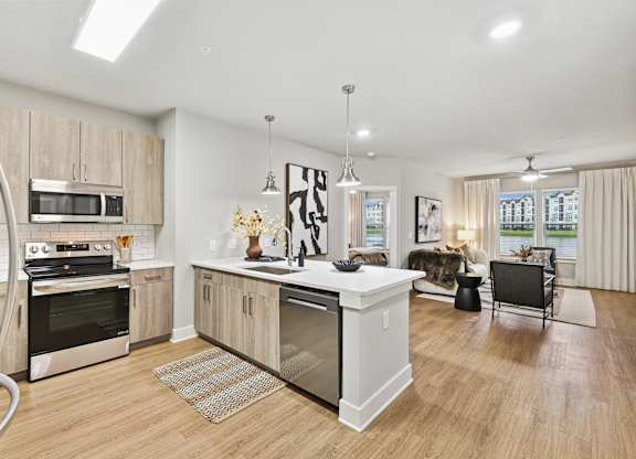 A modern kitchen with wooden cabinets and stainless steel appliances.at The Beacon at 331 Apartments, Santa Rosa Beach