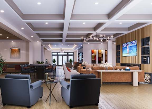 A modern living room with a large screen TV and comfortable seating.