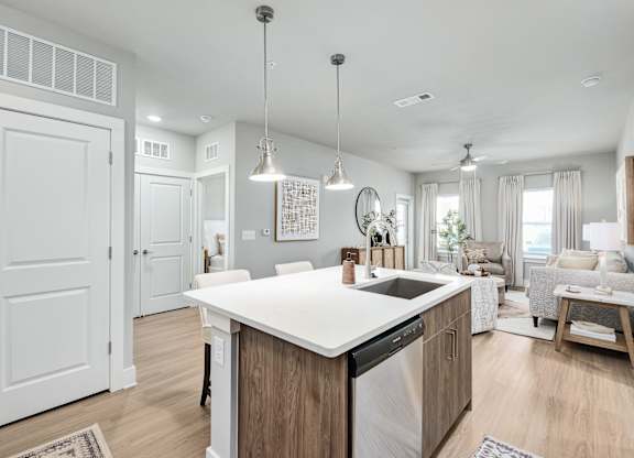 A modern kitchen with a large island and a dining area at The Ashton at East Park Apartments, Kennesaw, 30144
