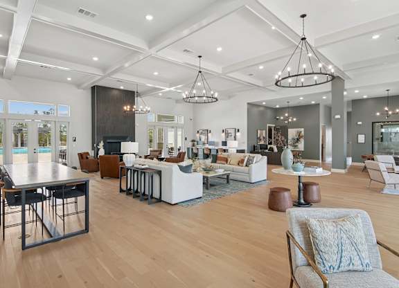 A modern living room with a pool table and a dining table at The Hendry Apartments, Fort Myers, 33905