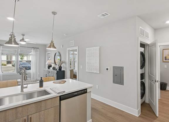 A modern kitchen with a white countertop and stainless steel appliances at The Hendry Apartments, Fort Myers, Florida