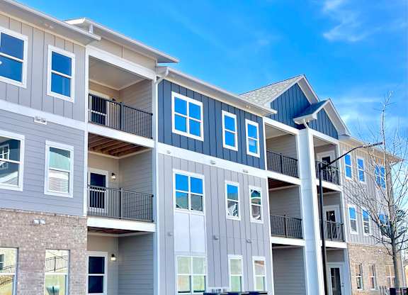 A modern apartment building with balconies and multiple windows at The Collective Upper Westside Apartments, Atlanta, GA, 30318