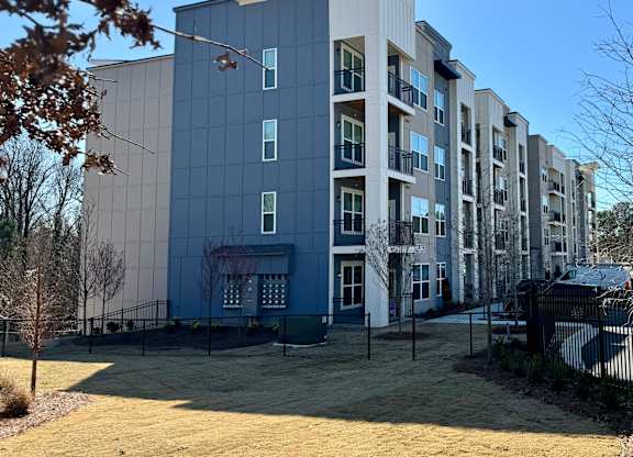 A modern apartment building with a mix of blue and white colors at The Collective Upper Westside Apartments, Atlanta, Georgia
