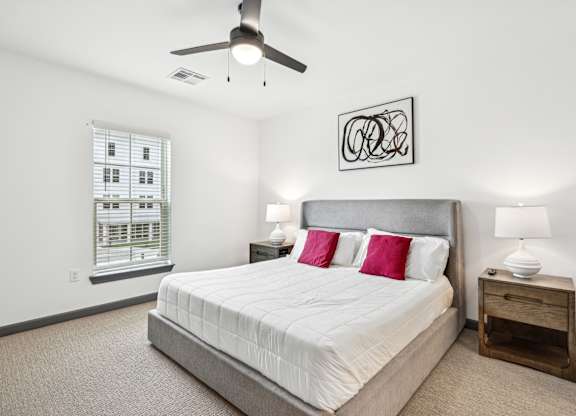 a bedroom with a large bed and a ceiling fan at The Leo Myrtle Beach, South Carolina