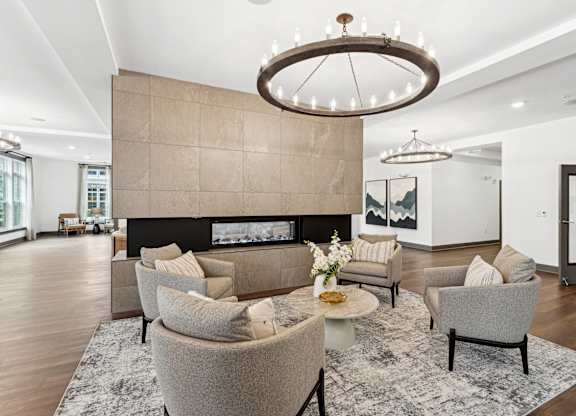a living room with couches and chairs and a fireplace at The Leo Myrtle Beach, Myrtle Beach, 29579