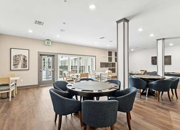 a dining room with a round table and chairs at The Leo Myrtle Beach, South Carolina
