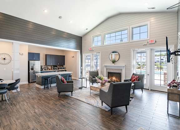 a living room with a fireplace and a table and chairs