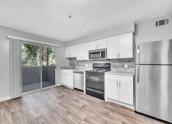 A Kitchen With Stainless Steel Appliances at Avondale Place Apartments, Avondale Estates, Georgia