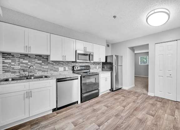 A Kitchen With White Cabinets at Avondale Place Apartments, Avondale Estates, 30002