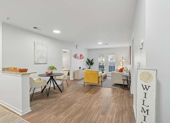 A living room with a wooden floor and furniture.
