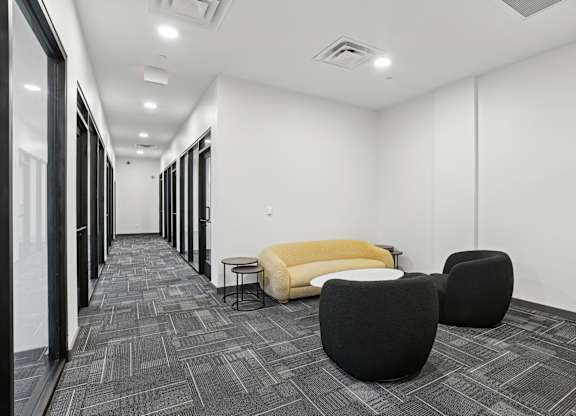 Hallway with Yellow Sofa at The 600 Apartments, Birmingham, AL