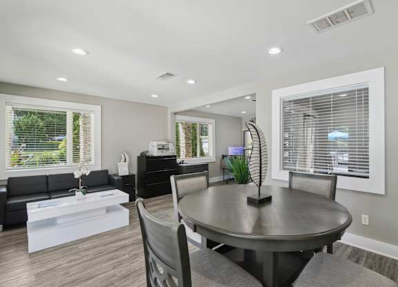 A modern dining room with a round table and chairs  at The Taylor, Marietta, GA.