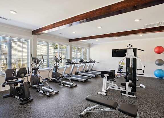 Gym with treadmills and other exercise equipment and windows  at The Meadows, Bloomingdale, GA