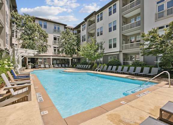 A large swimming pool surrounded by lounge chairs at Union Eleven Apartments, Atlanta, 30324