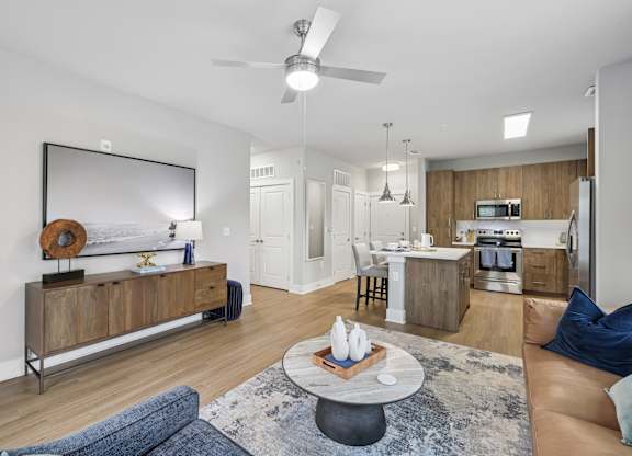 Living Area With Kitchen View at The Exchange at Crestview Apartments, Crestview, Florida