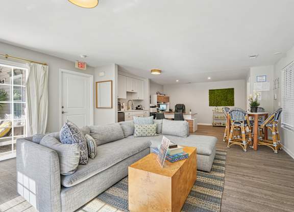 A living room with a grey couch and a wooden coffee table.