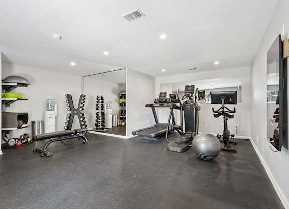 A spacious home gym with a variety of exercise equipment.
