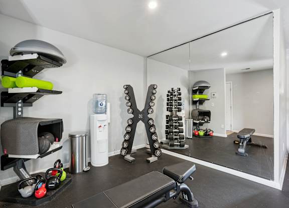 A well-equipped home gym with a variety of exercise equipment.