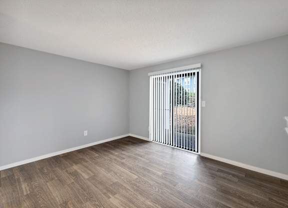 Living room with a sliding glass door to a patio  at Governors House, Huntsville, AL, 35805
