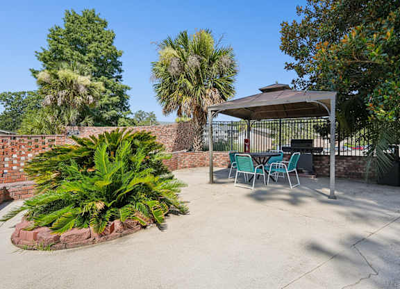 A patio with a table and chairs under a canopy.