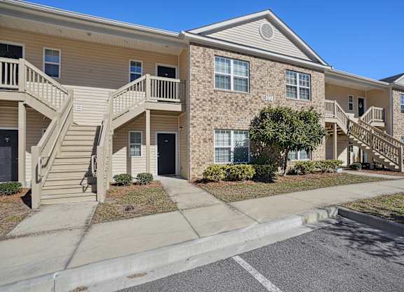 Apartment building with stairs and a sidewalk  at The Meadows, Bloomingdale, GA