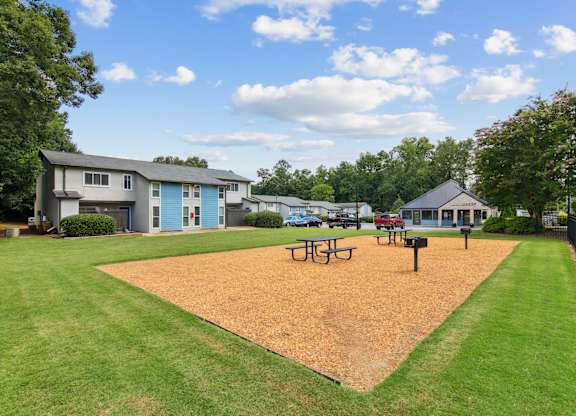 A park with a playground and picnic tables at The Taylor, Marietta, GA.