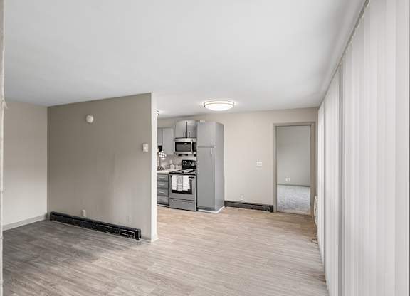 Kitchen area with a refrigerator, sink, and cabinets at Madison Flats, Madison, TN, 37115
