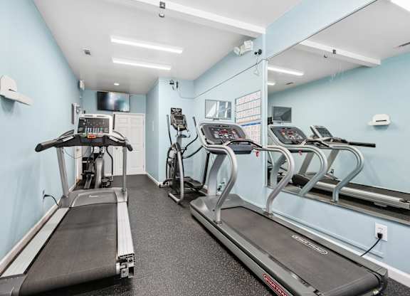 A gym with treadmills and exercise equipment.