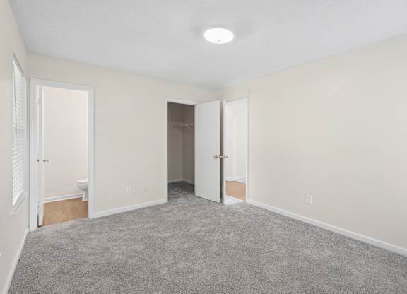 A room with carpeted floor and white walls.