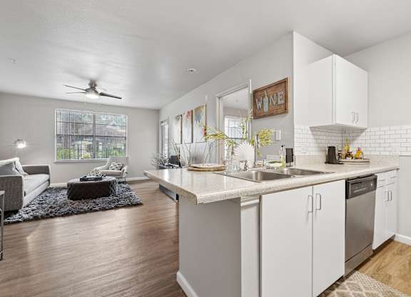 A kitchen with white cabinets and a large island.